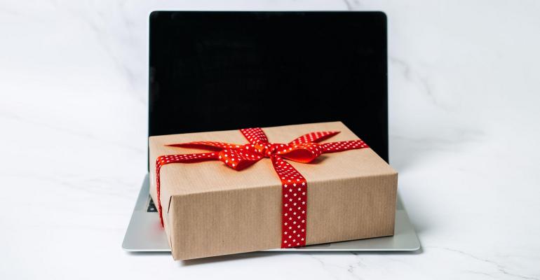 wrapped gift sitting on a laptop